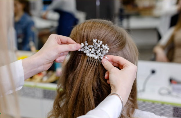 Hairpin being applied on a hair topper to make a wedding style